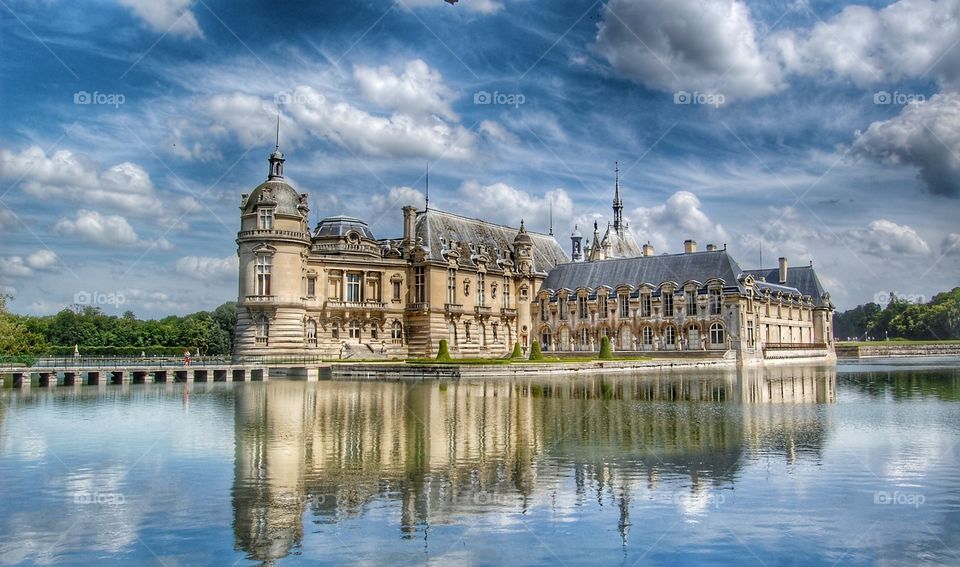 Chantilly Castle is reflected in the pond