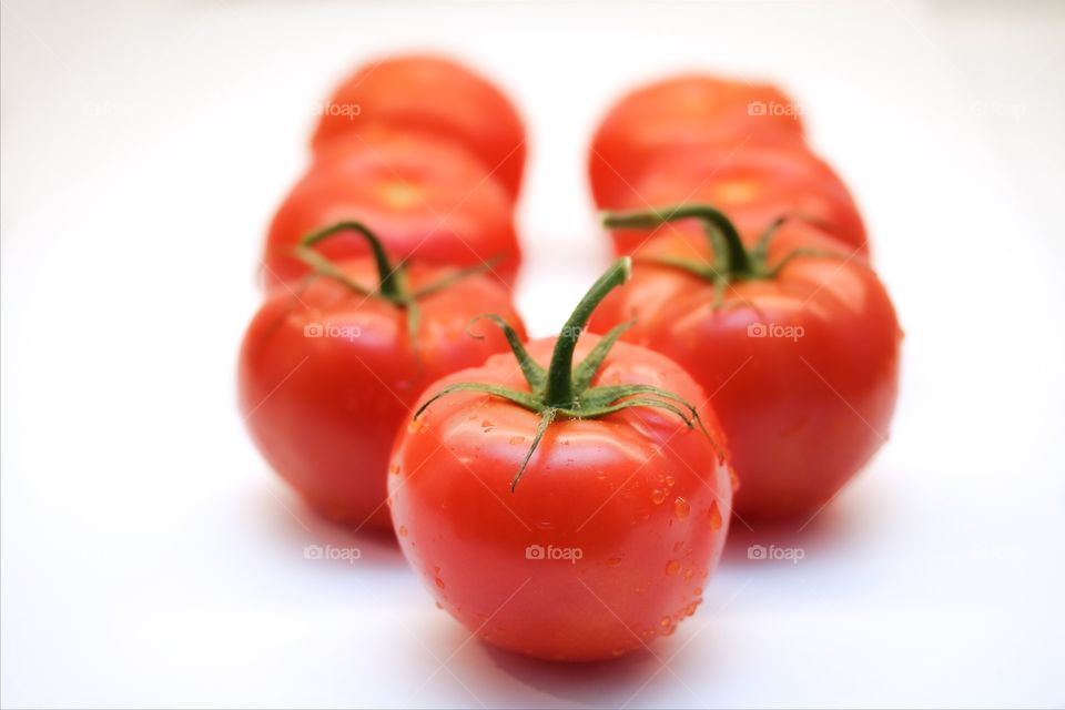 Red tomatoes over white background