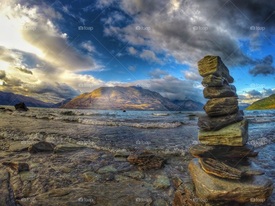 Rock stacks against river