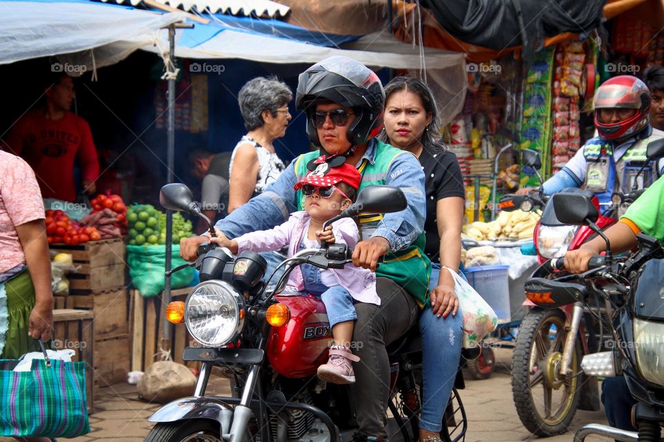 All family is riding the same motorcycle