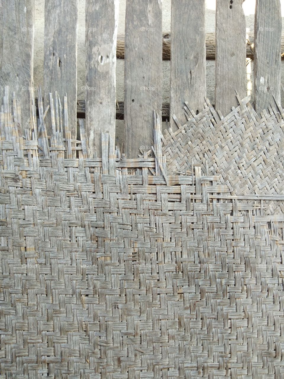 The weaved bamboo mats that are old and torn from use by laying the top of the litter for a long time.