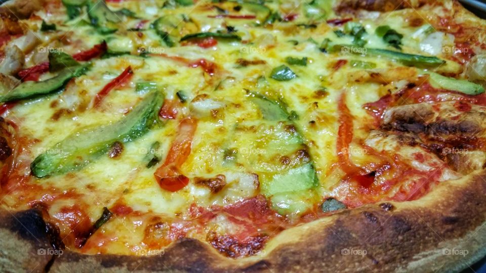 Pizza with sliced green and red bell peppers (capsicums).