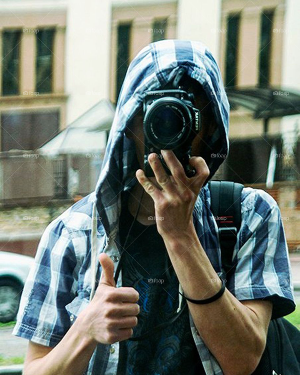 selfie in a blue shirt with a hood on a reflex camera in a reflection of shop windows

￼ Научиться произносить