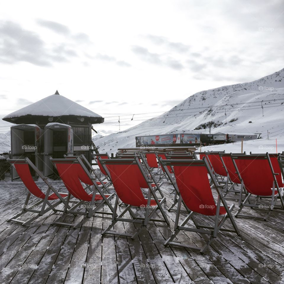 Deck chairs outside a ski resort restaurant 
