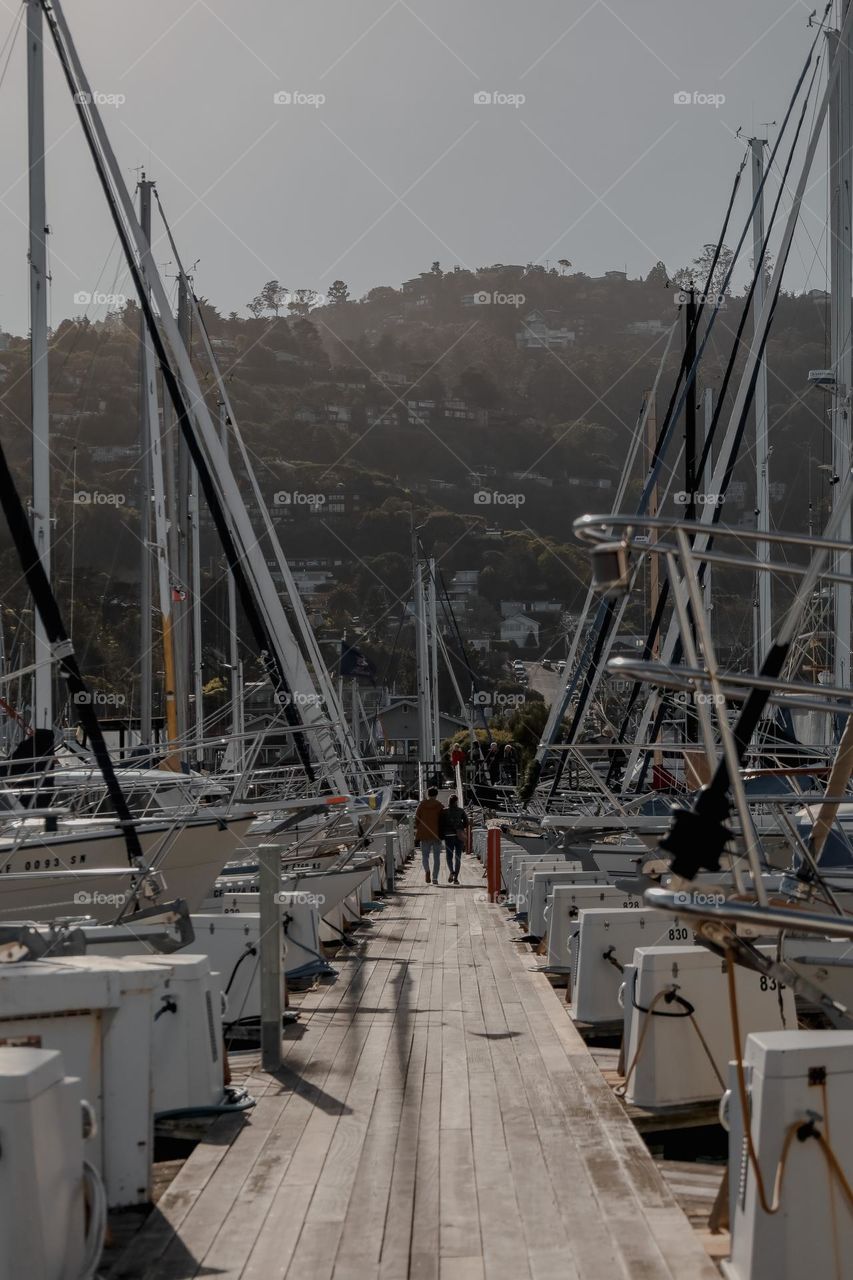 Couple walking around boats 