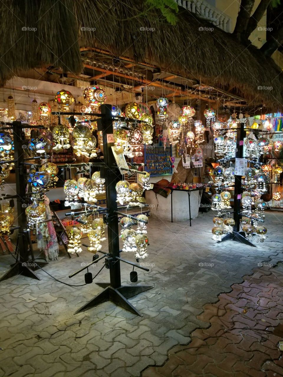 Late night shopping in Playa del Carmen, Mexico. Brightly lit, handmade lamps for sale.