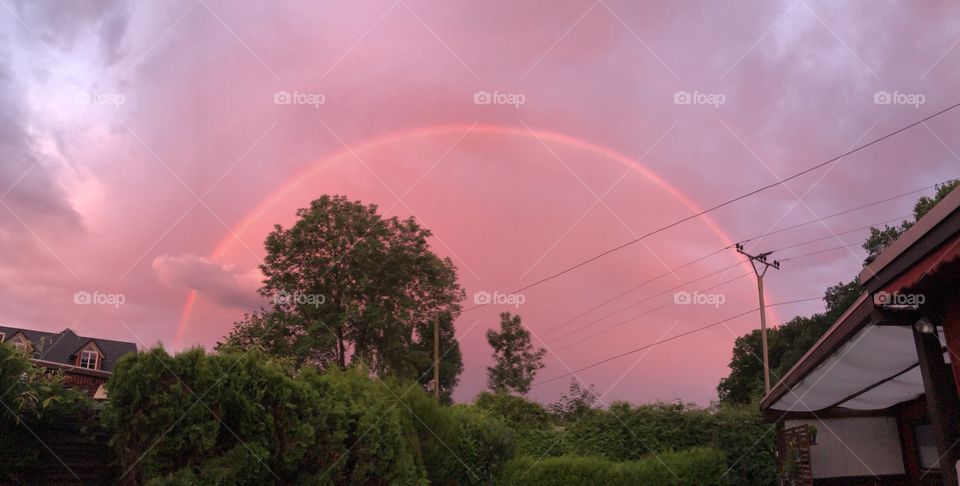 Rainbow in purple clouds sky