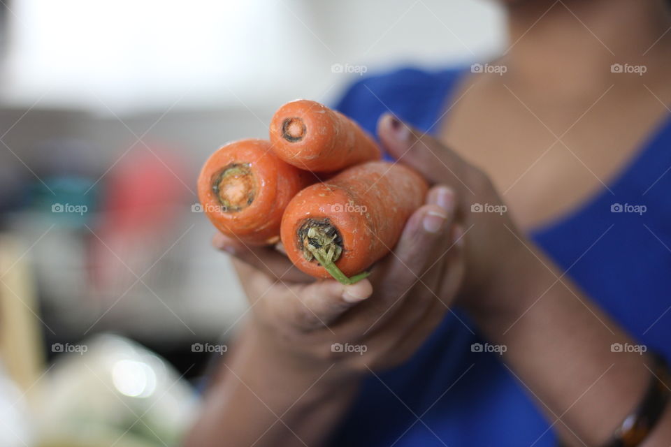 Close-up of woman holding carrots