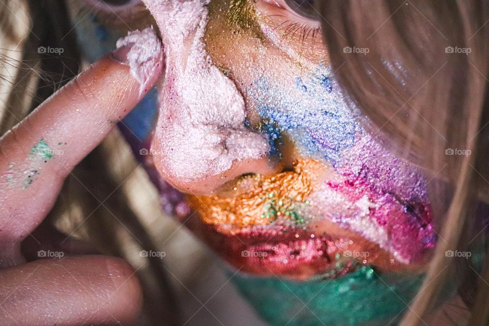 A child wearing glitter makeup