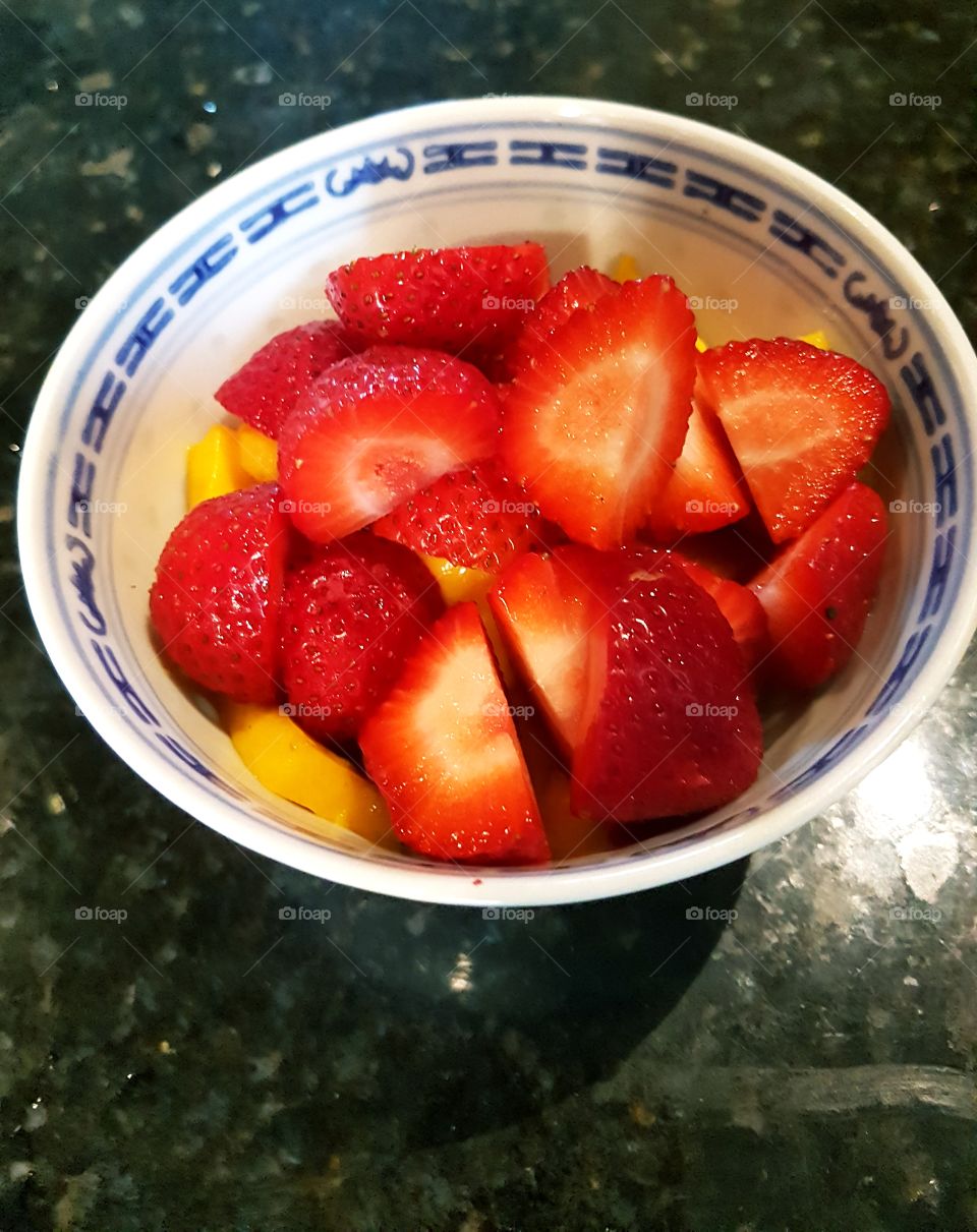 Strawberries and Mango in a bowl.