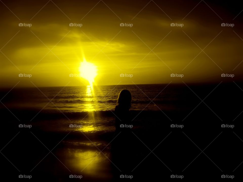 golden hour. girl on the beach during  the golden hour