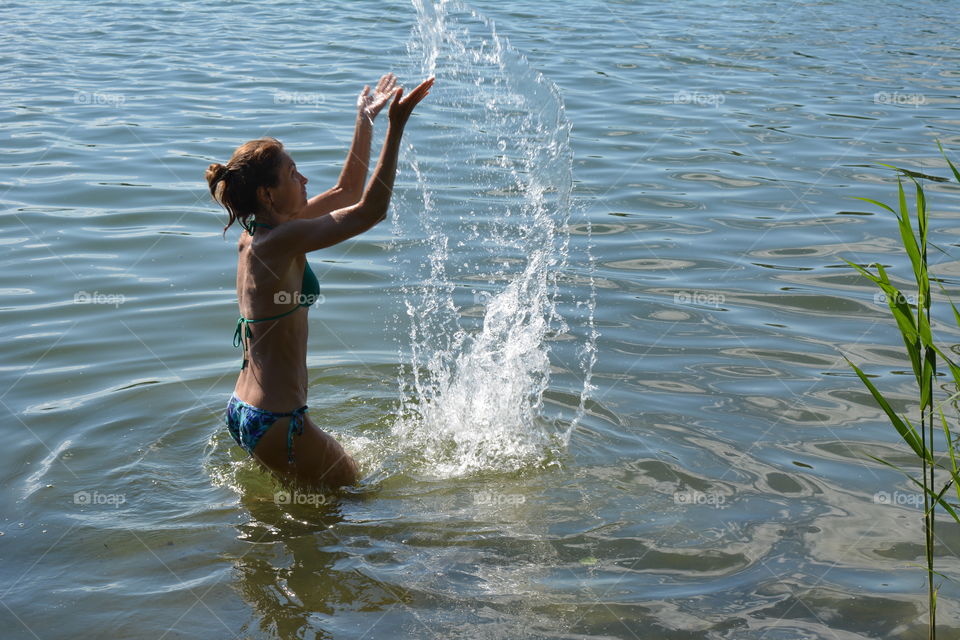 woman in the water lake summer heat, summer vacation