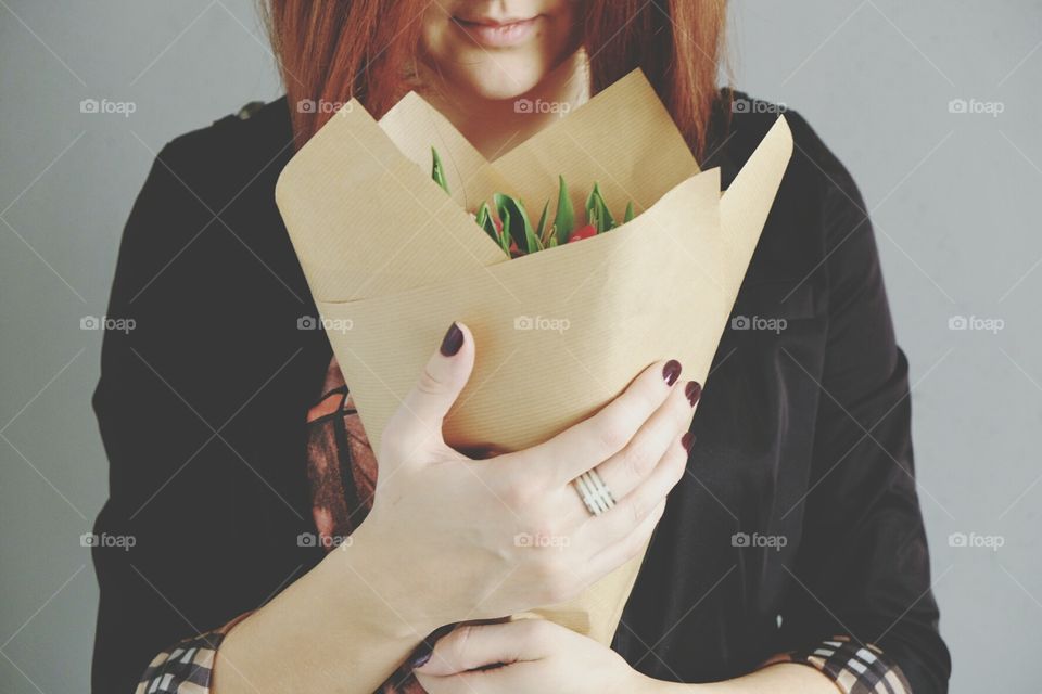 Girl with flowers in gift packages close up