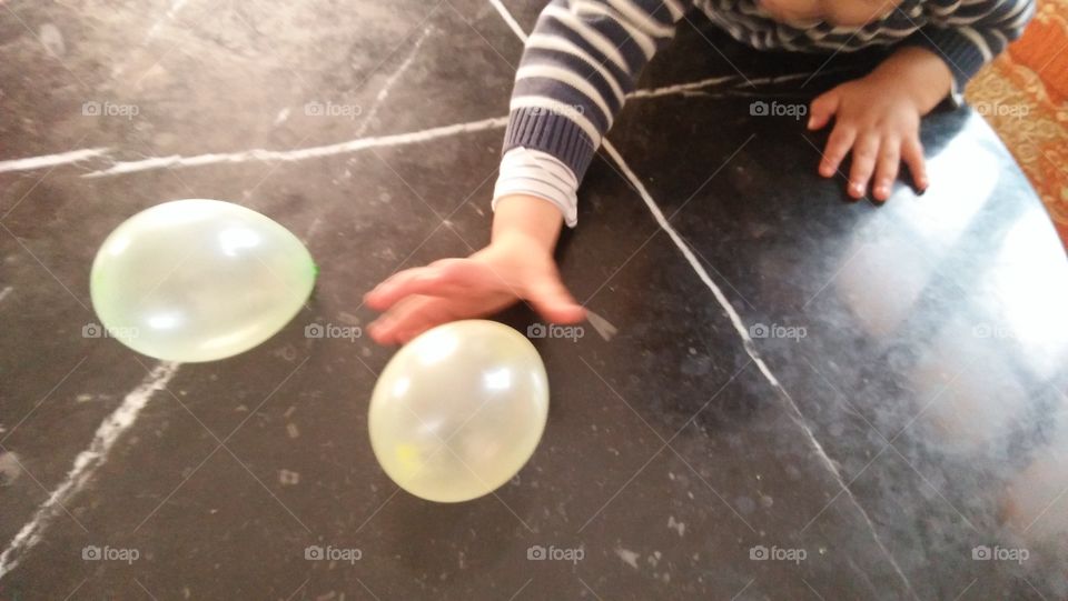 small boy hand try to  catch a balloon.