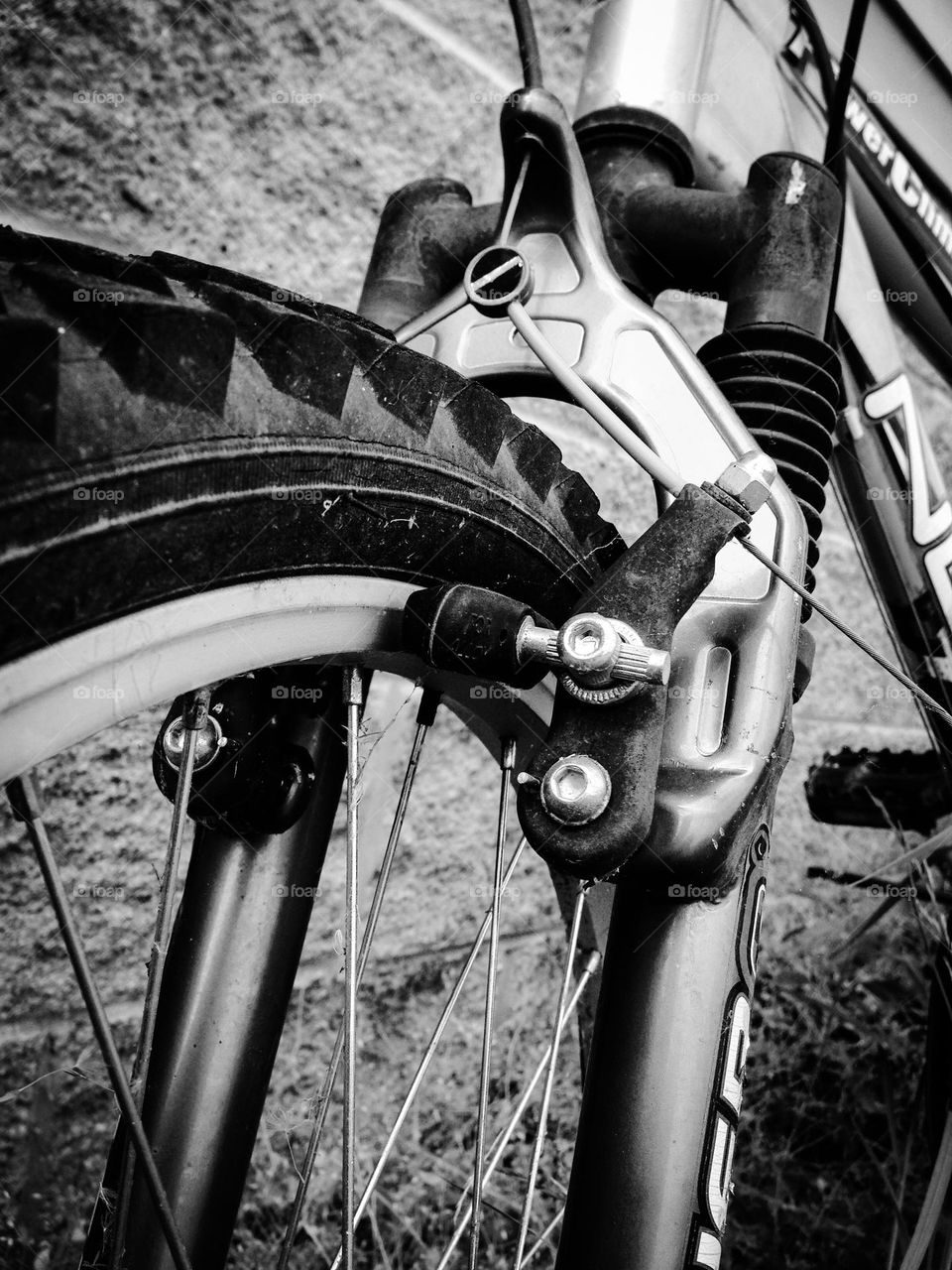 Black and white close up bicycle brakes and tire