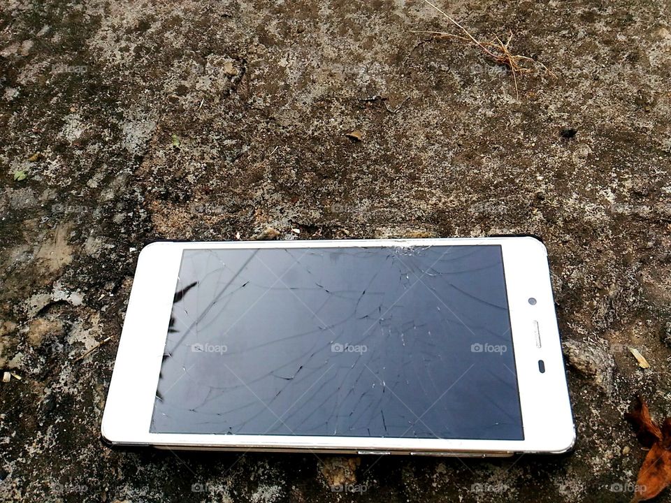 Mobile phone which fell on road and broke during  morning  walk.