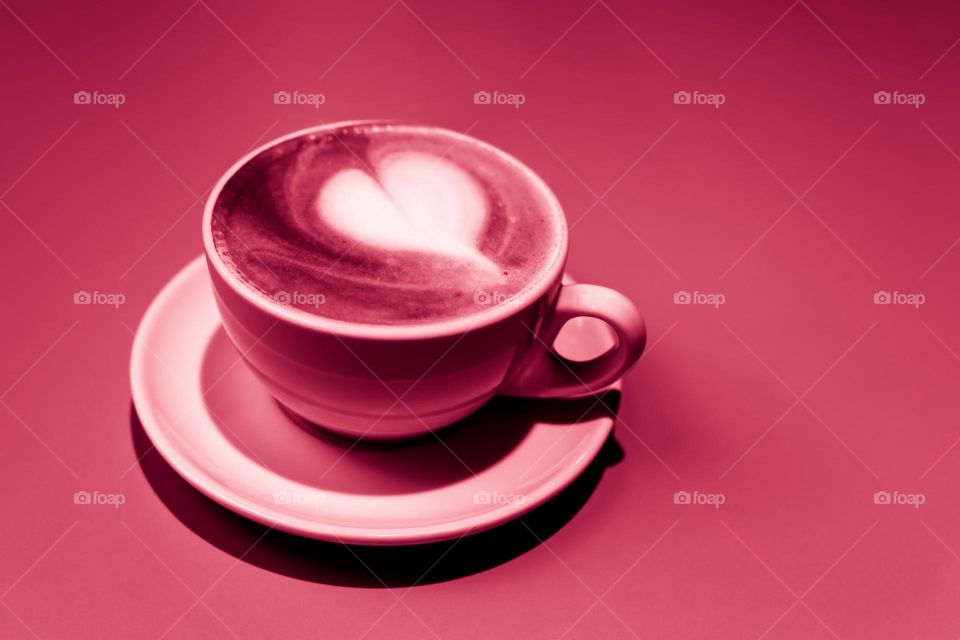 cup with cappuccino in viva magenta color