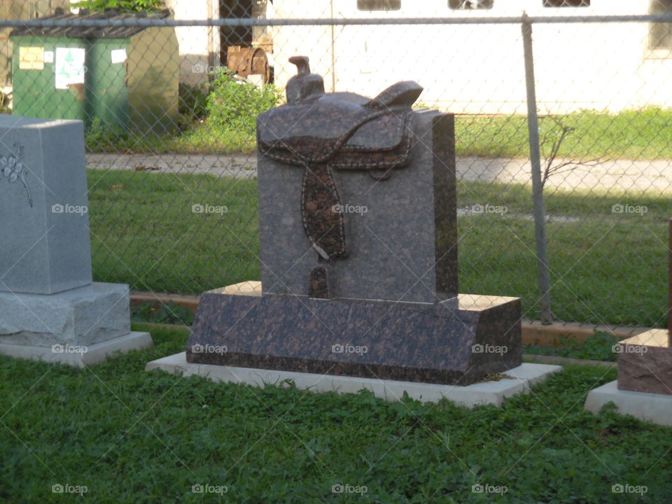 saddle head stone. I saw this head stone behind a funeral parlor
