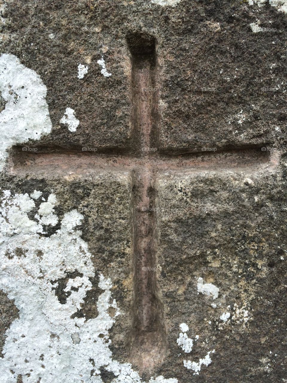 Faith. A carved cross from a 17th century tower