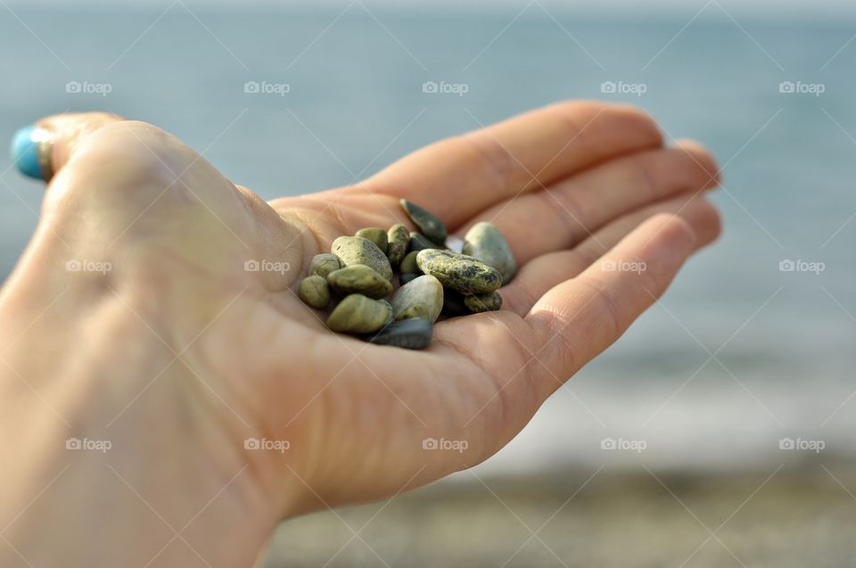 Small sea stones in hand 