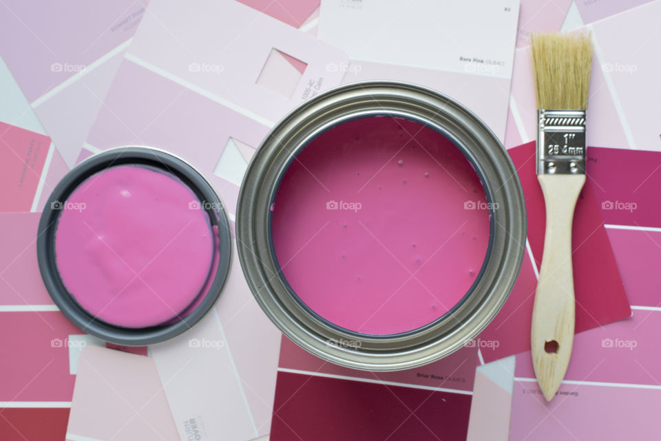 High angle view of pink paint and brush