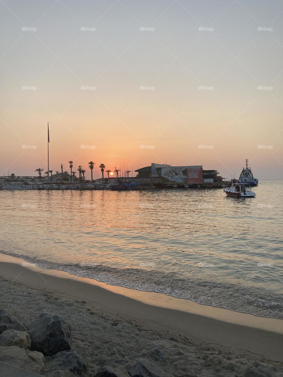 Sunset in Turkey. Blue sky and tall palm trees. Sunsets and sunny days. Summertime in Kusadasi. Vacation travel in Turkey . Summer view. Sunny day during vacation. Hidden gems and secret places.