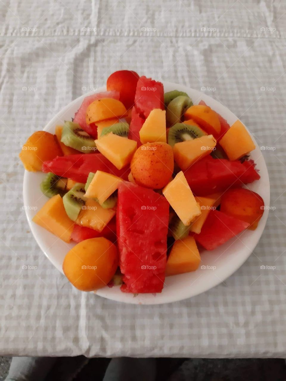 A colorful plate with fruits