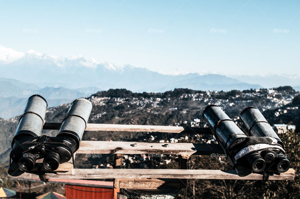 Telescopes, Binoculars, field glasses mounted for viewer to magnify (binocular vision) to see Kanchenjunga, Everest, Annapurna mountain range of distance area. Military tool used for surveillance.