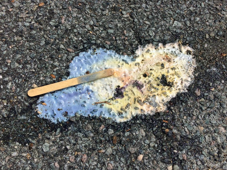 Melted popsicle on sidewalk