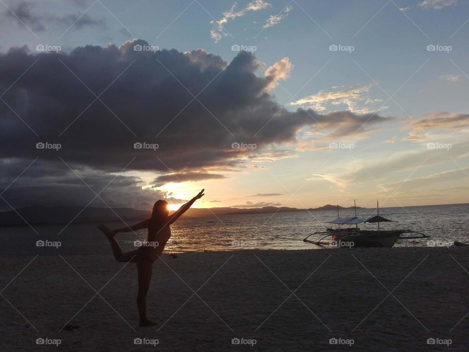 Balancing myself  in the sunset sky.