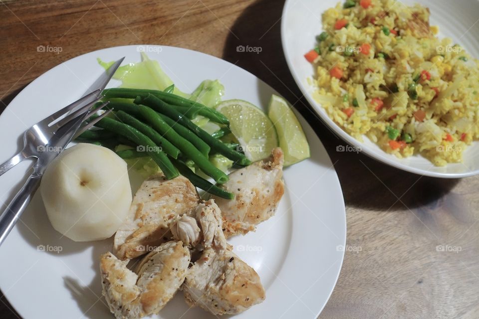 Simple menu ( chicken, vegetables, fruit and curry taste fried rice)