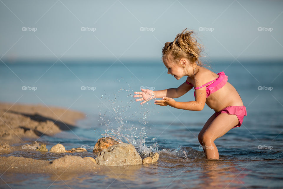 Little girl playing in the sea