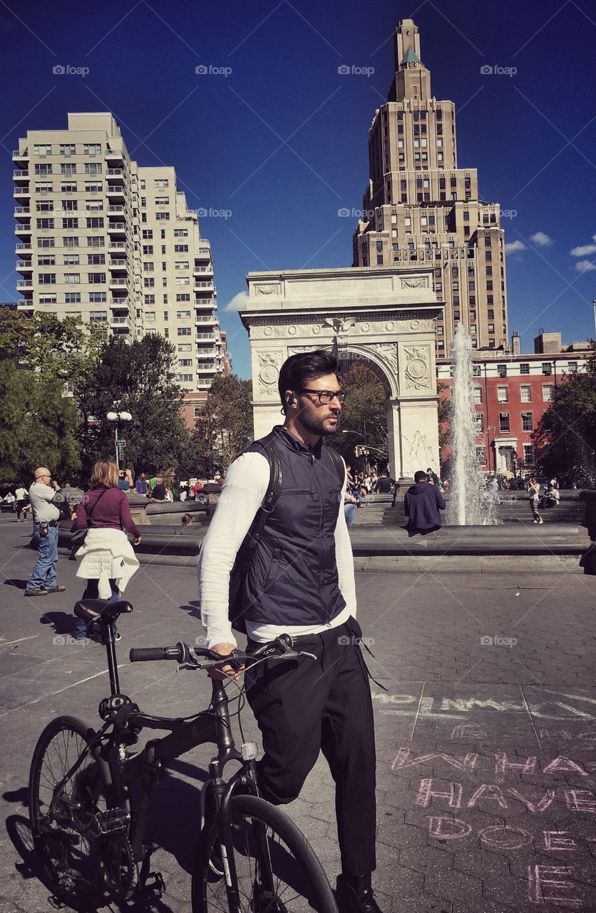 Man walks with his bicycle at Washington Square Park in New York 