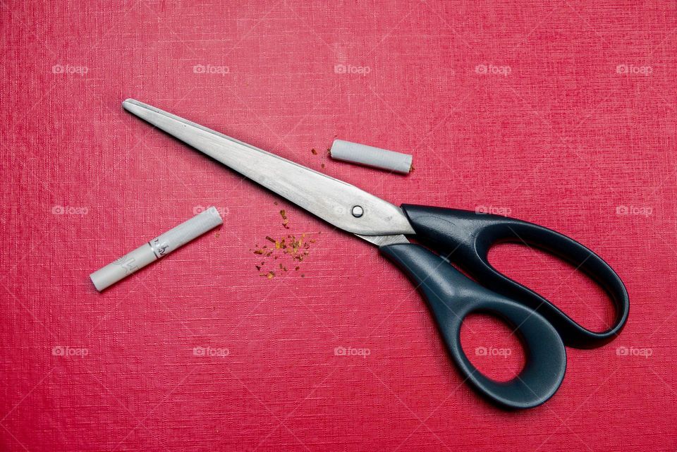 New Year's resolutions to quit smoking. Cigarette and scissors.