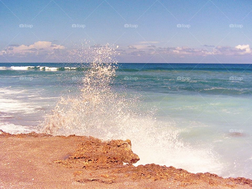 Waves crashing against rocky shoreline, Blowing Rocks Preserve Jupiter, Florida