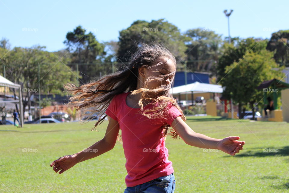 Little girl dancing outdoors