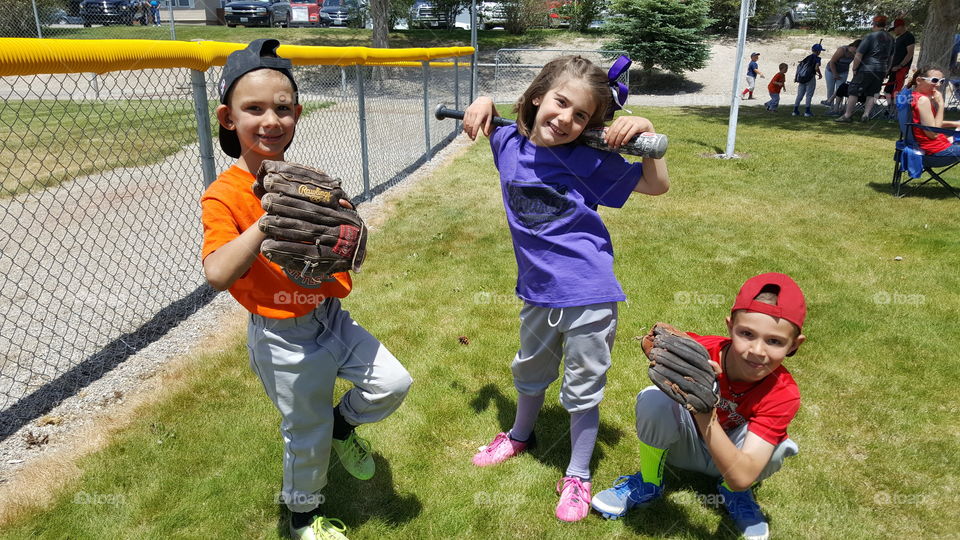 baseball players kids having fun gloves bats cleats uniforms boys girls in Ely Nevada USA 2017