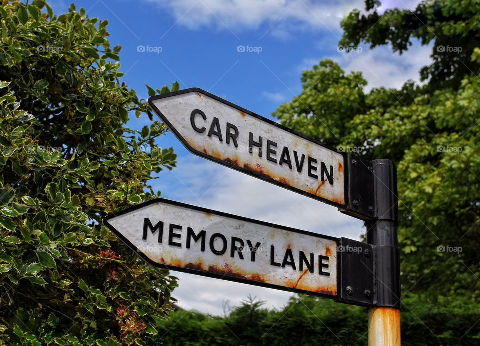 A direction sign pointing towards memory lane and car heaven.