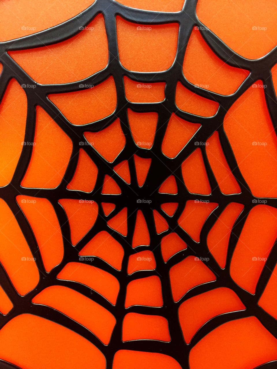 Web. A spider web image against a orange background perfect for Halloween.