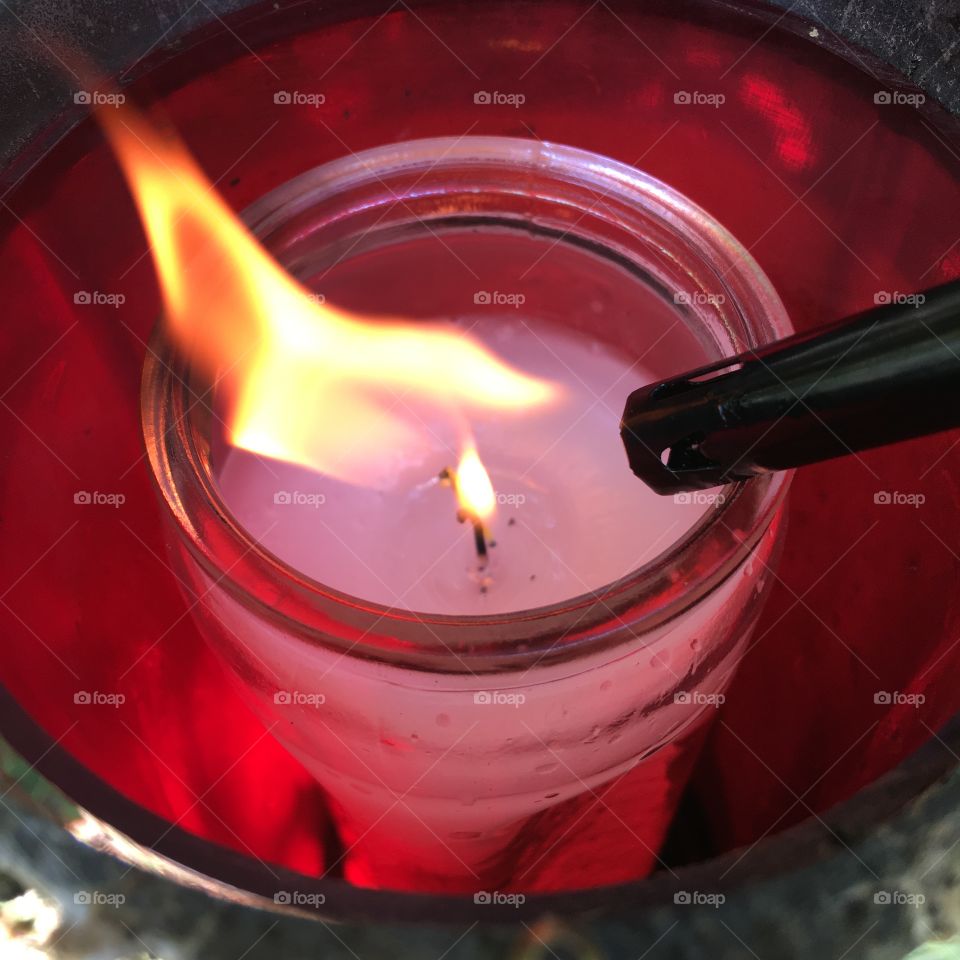 Lighting red vigil candle at the cemetery 🔥