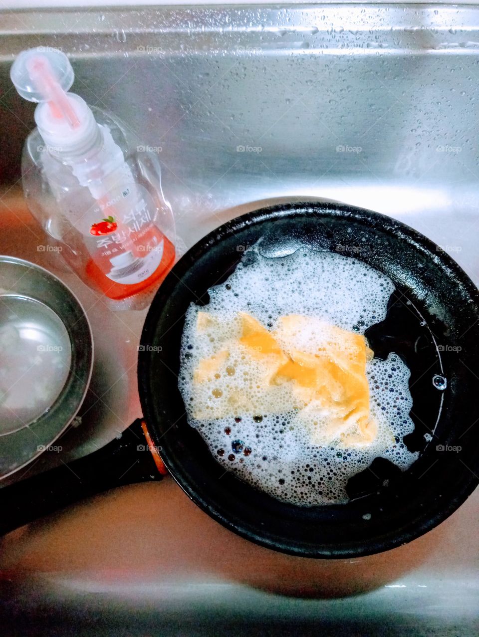 washing kitchen stuff with a liquid soap.
to make the kitchen stuff safe and clean. using liquid soap to wash it with a good scratch clothes will make the work faster, easy and clean.
