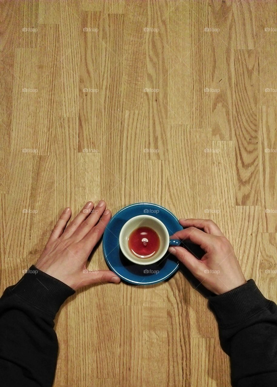 Hands holding cup od coffee