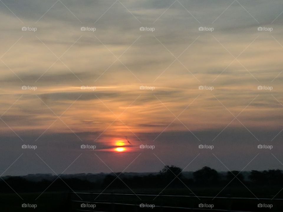 cloud slicing through the sun