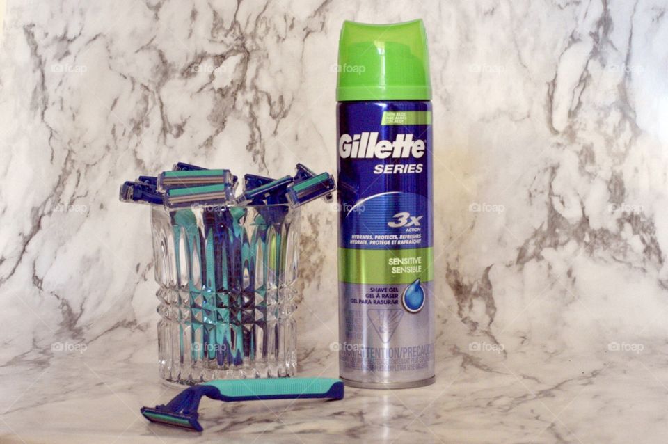 Gillette disposable razors and Gillett series 3X shave cream on a marble background 