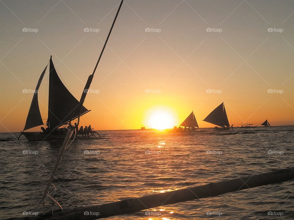 Silhouette of sailboat at beach