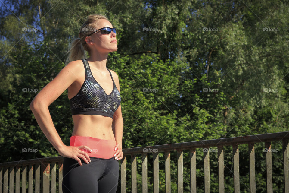 Athlete woman wearing sunglasses looking away