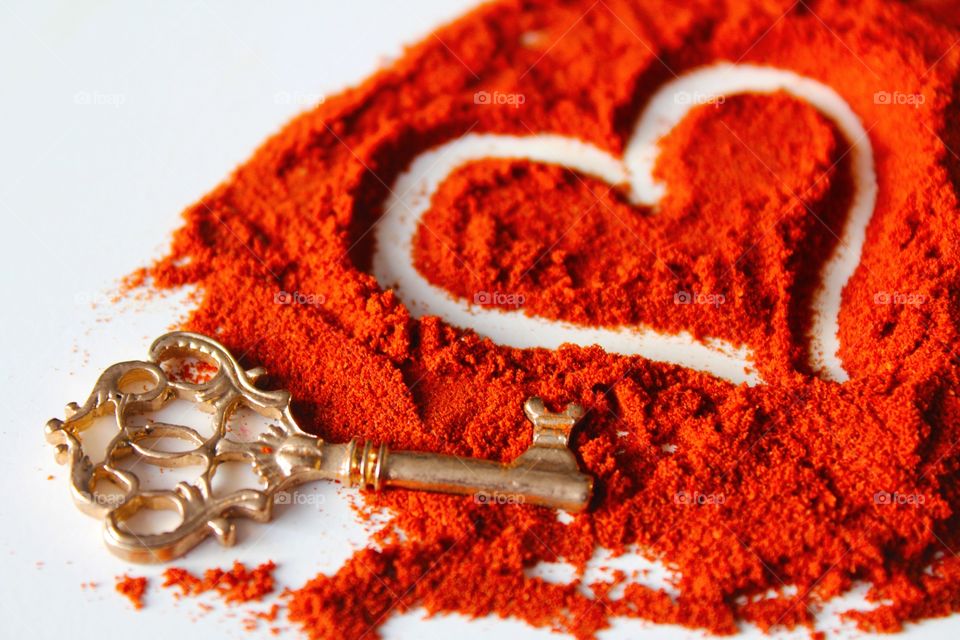 Close-up of key with heart shape paprika powder