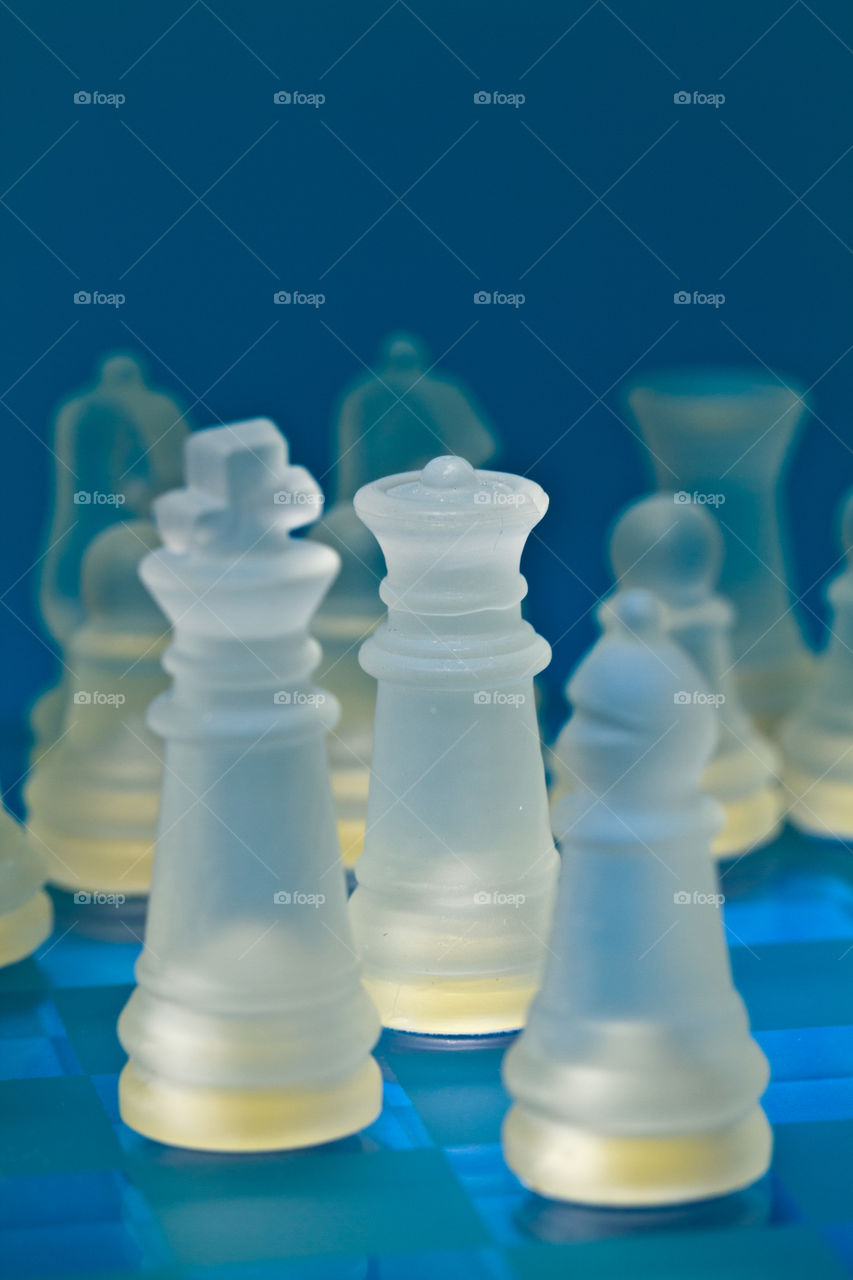 glass chess pieces on the move