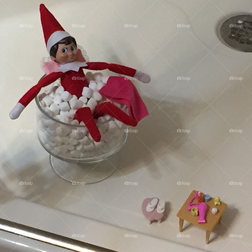 Elf on a shelf in a marshmallow bubble bath posed for Christmas 