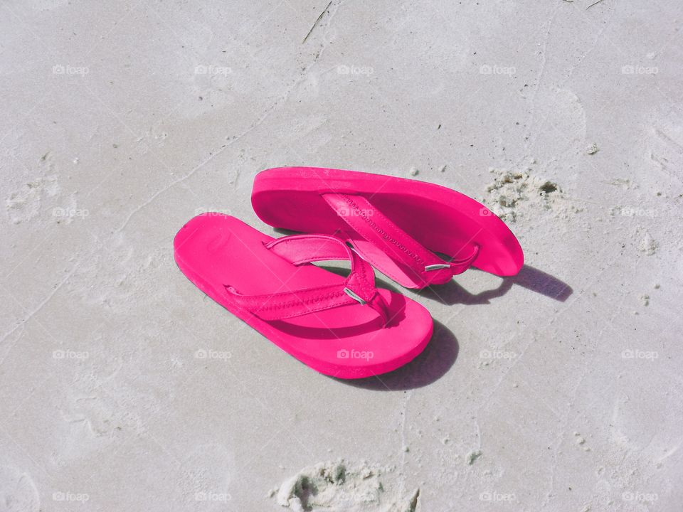Pink Flip Flops on sand